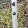 Claw insulator on round post in field